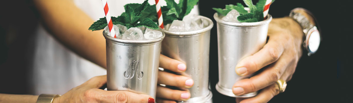 hands holding julep cups